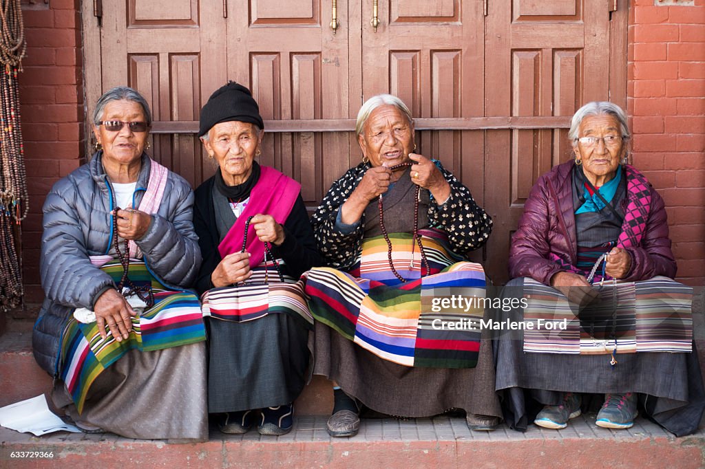 Women in Tibetan dress with mala beads