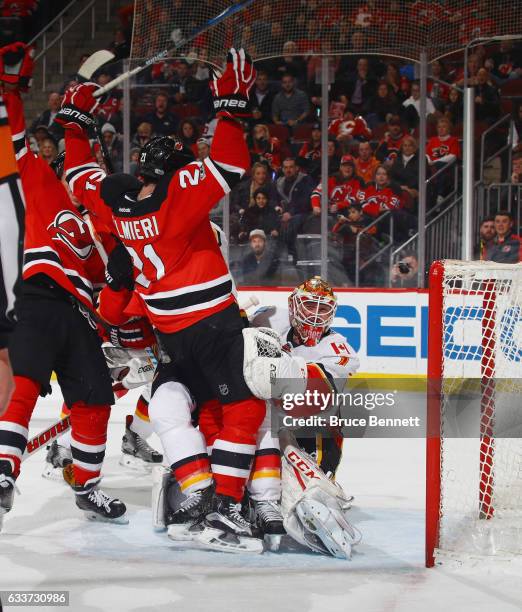 Kyle Palmieri of the New Jersey Devils celebrates his powerplay goal against Brian Elliott of the Calgary Flames at 19:36 of the second period at the...