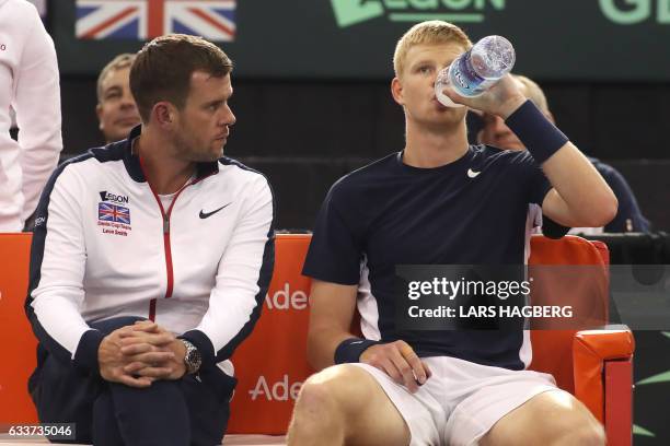 Kyle Edmund of Team Great Britain speaks with Team Great Britain's coach Leon Smith during a break in the game against Canada's Vasek Pospisil during...