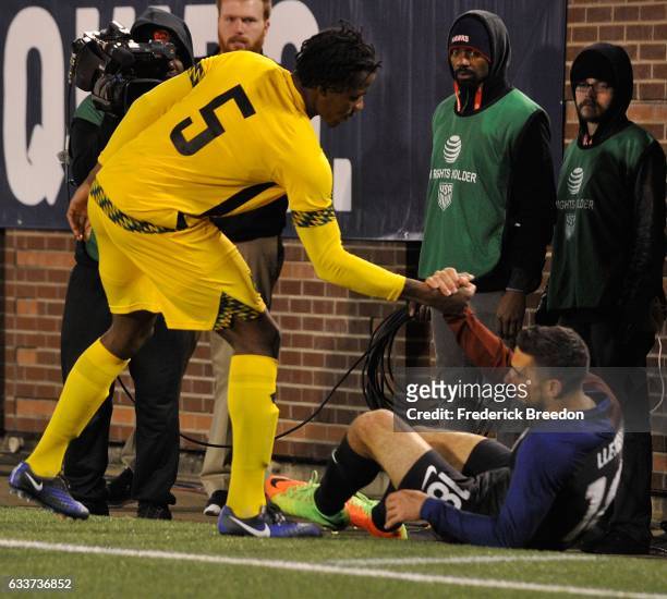 Alvas Powell of Jamaica helps up Sebastian Lletget of USA during the second half of a friendly international match at Finley Stadium on February 3,...