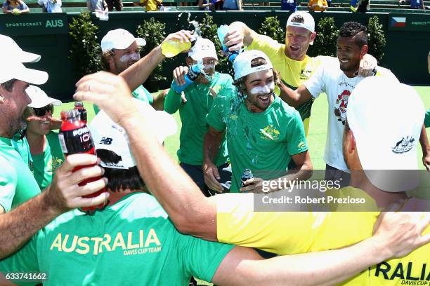 Jordan Thompson of Australia has drinks poured on him by team-mates after winning the tie against Czech Republic during the first round World Group...