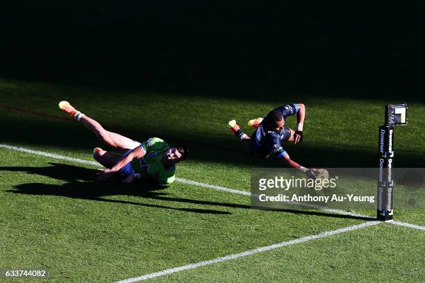 Gideon Gela-Mosby of the Cowboys scores a try against Nick Cotric of the Raiders during the 2017 Auckland Nines match between the Cowboys and the...
