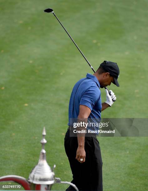 Tiger Woods of the USA reacts to his tee shot on the 1st hole during the first round of the Omega Dubai Desert Classic at Emirates Golf Club on...