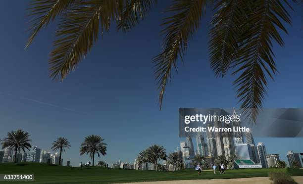 Players walk up the eighth hole during the completion of the weather delayed second round of the Omega Dubai Desert Classic on the Majlis Course at...