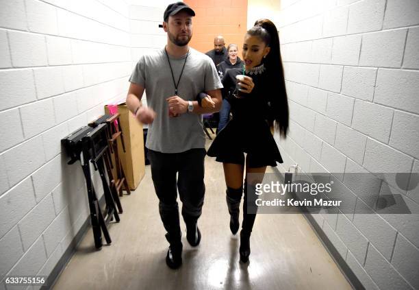 Scooter Braun and Ariana Grande walk backstage during the "Dangerous Woman" Tour Opener at Talking Stick Resort Arena on February 3, 2017 in Phoenix,...