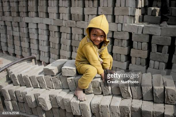 A child is playing in a brickfield while his parents work in the brickfiled, on February 4, 2017. Narayanganj, Bangladesh, on February 4, 2017.