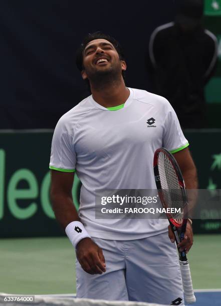 Pakistani tennis player Aisam-Ul-Haq Qureshi reacts after a point against Iranian players Shahin Khaledan and Alborz Akhavan during their men's...