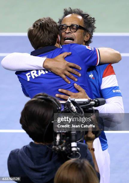 Captain of Team France Yannick Noah greets Nicolas Mahut of France after his win with Pierre-Hughes Herbert of France in the doubles match on day 2...
