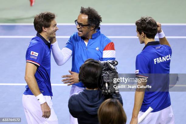 Captain of Team France Yannick Noah greets Nicolas Mahut and Pierre-Hughes Herbert of France after their win in the doubles match on day 2 of the...