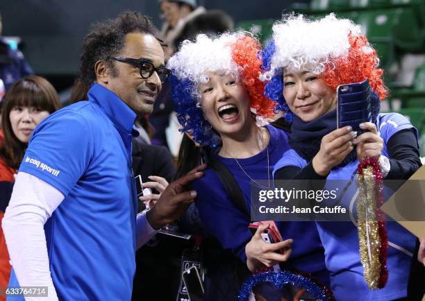 Captain of Team France Yannick Noah poses with fans after winning the doubles match and the tie 3-0 on day 2 of the Davis Cup World Group first round...