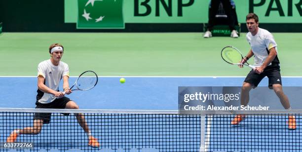 Alexander Zverev of Germany and Mischa Zverev of Germany in action against Ruben Bemelmans of Belgium and Joris De Loore of Belgium during day two of...