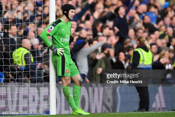 Petr Cech of Arsenal reacts after a mistake led to Cesc Fabregas of Chelsea scoring his team's thirs goal during the Premier League match between...