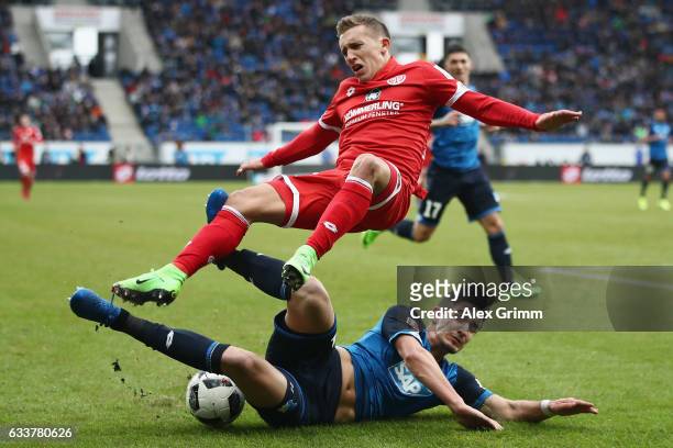 Pablo de Blasis of Mainz is challenged by Benjamin Huebner of Hoffenheim during the Bundesliga match between TSG 1899 Hoffenheim and 1. FSV Mainz 05...