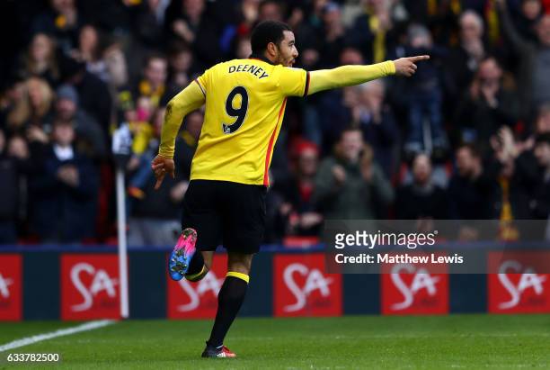 Troy Deeney of Watford celebrates scoring his sides first goal during the Premier League match between Watford and Burnley at Vicarage Road on...
