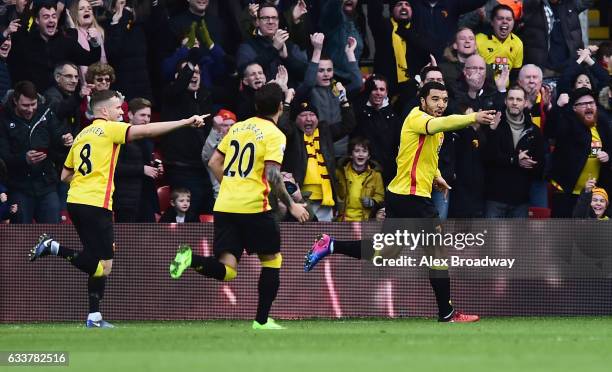 Troy Deeney of Watford celebrates scoring his sides first goal during the Premier League match between Watford and Burnley at Vicarage Road on...