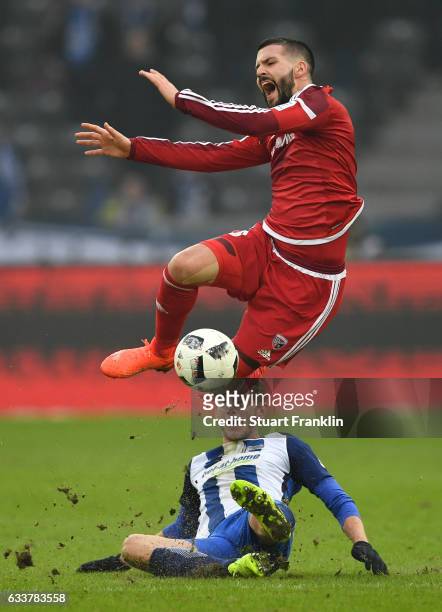 Fabian Lustenberger of Berlin is challenged by Anthony Jung of Ingolstadt during the Bundesliga match between Hertha BSC and FC Ingolstadt 04 at...