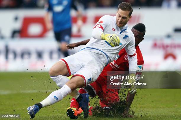 Goalkeeper Oliver Baumann of Hoffenheim is challenged by Jhon Cordoba of Mainz during the Bundesliga match between TSG 1899 Hoffenheim and 1. FSV...