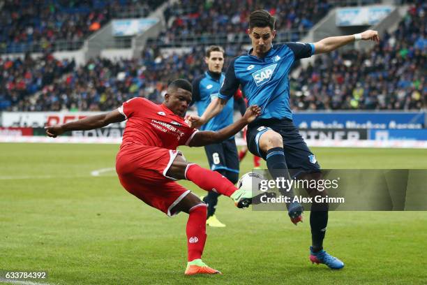 Jhon Cordoba of Mainz is challenged by Benjamin Huebner of Hoffenheim during the Bundesliga match between TSG 1899 Hoffenheim and 1. FSV Mainz 05 at...