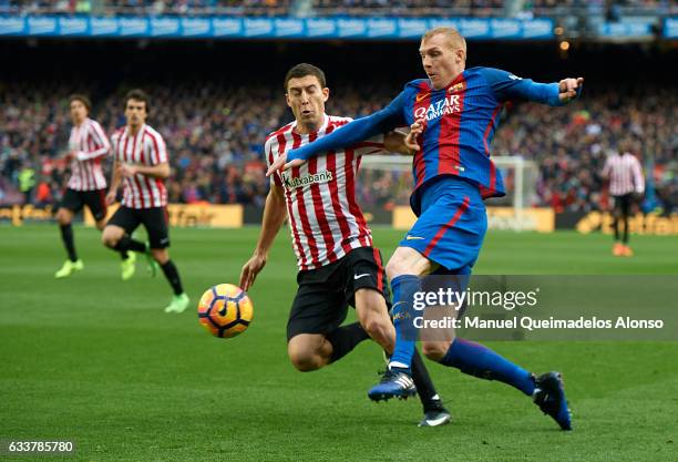 Jeremy Mathieu of Barcelona competes for the ball with Oscar de Marcos of Athletic Club during the La Liga match between FC Barcelona and Athletic...