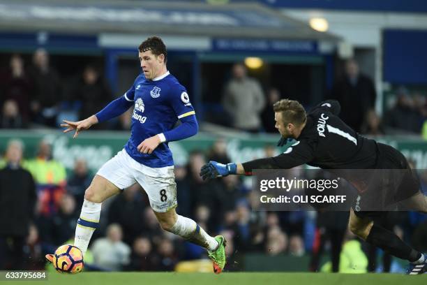 Everton's English midfielder Ross Barkley goes around Bournemouth's Polish goalkeeper Artur Boruc on his way to scoring their sixth goal during the...