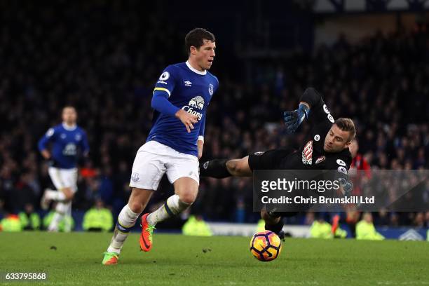 Ross Barkley of Everton rounds Artur Boruc of AFC Bournemouth before scoring his side's sixth goal during the Premier League match between Everton...