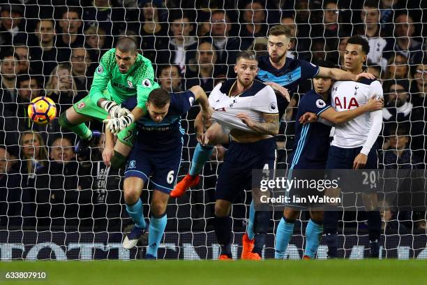 Victor Valdes of Middlesbrough attempts to punch clear as Ben Gibson of Middlesbrough tangles with Toby Alderweireld of Tottenham Hotspur during the...