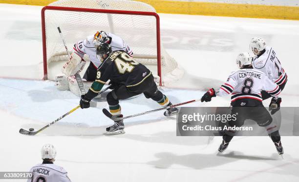 Michael McNiven of the Owen Sound Attack gets set to stop a scoring attempt by Max Jones of the London Knights during an OHL game at Budweiser...