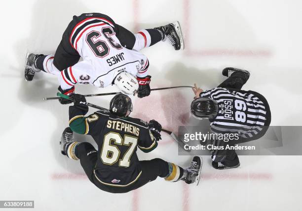 Cordell James of the Owen Sound Attack takes a faceoff against Mitchell Stephens of the London Knights during an OHL game at Budweiser Gardens on...