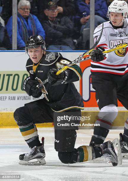 Max Jones of the London Knights battles against the Owen Sound Attack during an OHL game at Budweiser Gardens on February 3, 2017 in London, Ontario,...