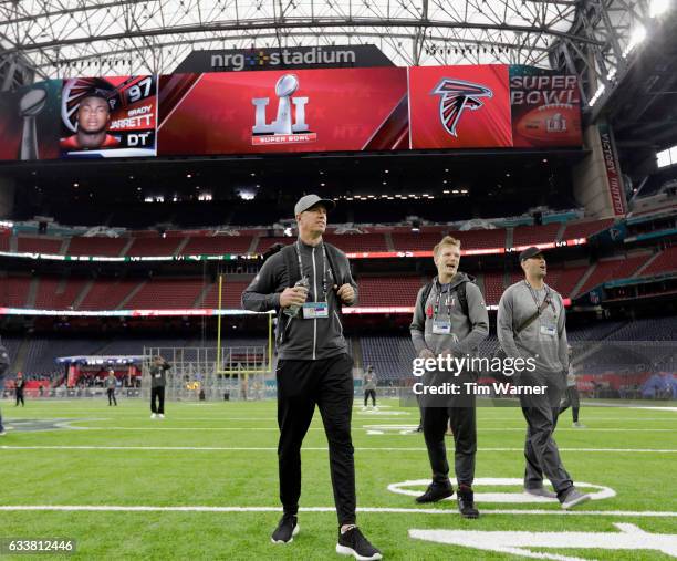 Matt Ryan of the Atlanta Falcons, Matt Schaub, and Matt Simms#4 walk on the turf during the Super Bowl LI team walk through at NRG Stadium on...