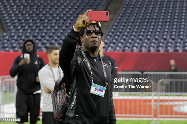Sean Weatherspoon of the Atlanta Falcons takes a photo during the Super Bowl LI team walk through at NRG Stadium on February 4, 2017 in Houston,...