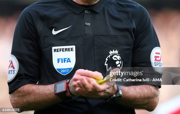 Detail of a FIFA referee badge on a Premier League shirt as he writes a yellow card during the Premier League match between Chelsea and Arsenal at...