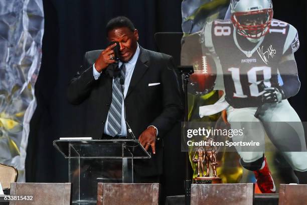 Hall of Famer Jackie Slater wipes away tears as he speaks to the audience after he receives the Bart Starr Award for his son New England Patriots...
