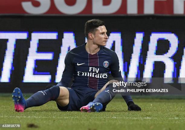 Paris Saint-Germain's German forward Julian Draxler sits on the pitch after missing a goal during the French L1 football match between Dijon FCO and...