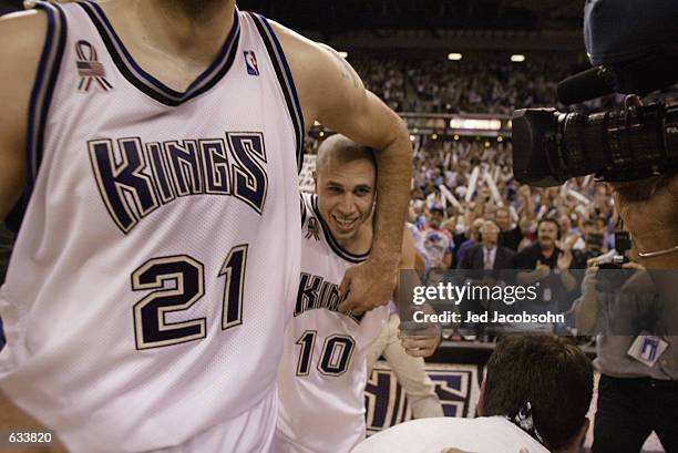 Point guard Mike Bibby of the Sacramento Kings emerges from a headlock by center Vlade Divac after winning Game five of the Western Conference Finals...