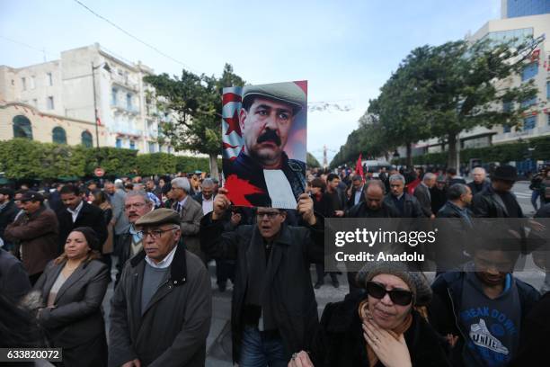 Tunisians gather during the death anniversary of the Chokri Belaid as they demand from Government to unveil the mystery of his death, in Tunis,...