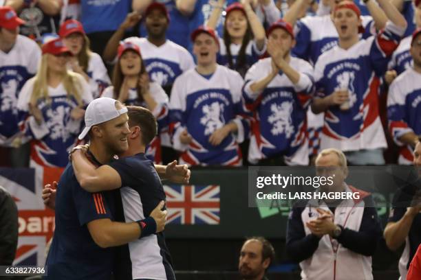 Leon Smith coach for Great Britain gives Dominc Inglot a hug after he and Jamie Murray beat Daniel Nestor and Vasek Pospisil of Canada during the...