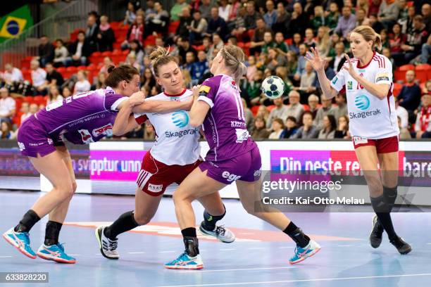 Amanda Kurtovic pass the ball to Gro Hammerseng-Edin as Trine Ostergaard Jensen and Veronica Kristiansen tries to block in the game between Larvik HK...