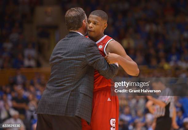 Head coach Mark Gottfried of the North Carolina State Wolfpack hugs Dennis Smith Jr. #4 of the North Carolina State Wolfpack during their win against...