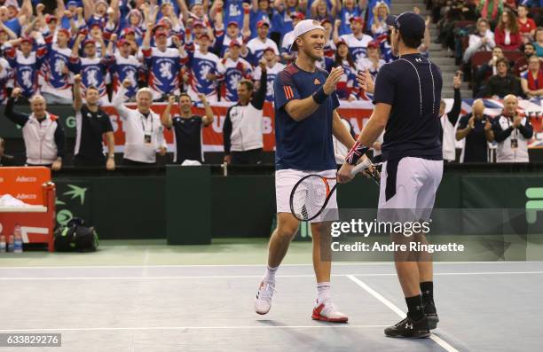 Dominic Inglot and Jamie Murray of Great Britain celebrate their win over Vasek Pospisil and Daniel Nestor of Canada after the doubles match on day...