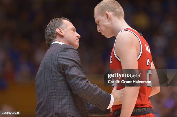 Head coach Mark Gottfried of the North Carolina State Wolfpack talks with Maverick Rowan of the North Carolina State Wolfpack during their win...