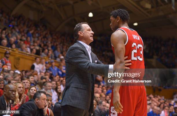 Head coach Mark Gottfried of the North Carolina State Wolfpack talks with Ted Kapita of the North Carolina State Wolfpack during their win against...