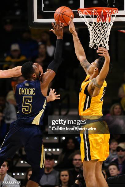 Wake Forest Demon Deacons forward John Collins blocks a shot by Georgia Tech Yellow Jackets guard Josh Okogie during the first half on February 4,...