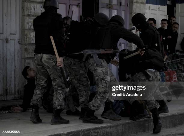 Palestinian police take a protester into custody as Al-Tahrir Party supporters protest against the Palestinian government handing land over to the...