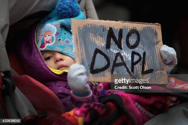 Child holds a sign during a rally protesting the construction of the Dakota Access pipeline on February 4, 2017 in Chicago, Illinois. President...