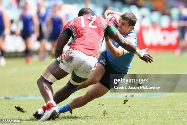 Vladislav Lazarenko of Russia is tackled by Willy Ambaka of Kenya during the Challenge Trophy Quarter Final match between Kenya and Russia in the...