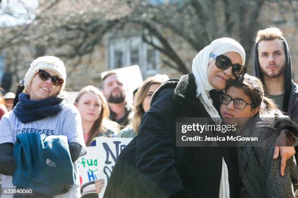 Palestinian immigrant and American citizen Kareema Sabdah hugs her daughter, Jenna during an Interfaith Rally for Muslims and Refugees at the...