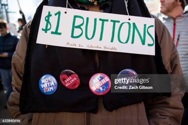 Demonstrator sells buttons during a rally in front of the White House on February 4, 2017 in Washington, DC. The demonstration was aimed at President...