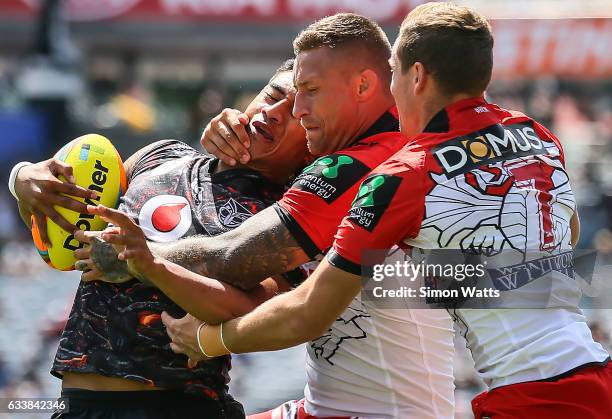 Ata Hingano of the Warriors is tackled by Tariq Sims and Kurt Mann of the Dragons during the 2017 Auckland Nines match between the New Zealand...