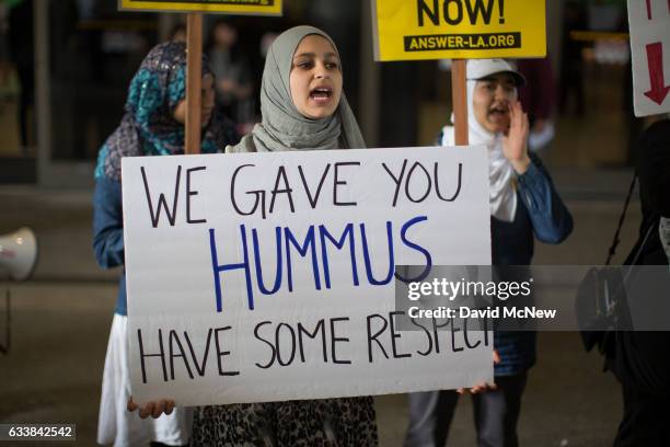 Demonstrators support a ruling by a federal judge in Seattle that grants a nationwide temporary restraining order against the presidential order to...